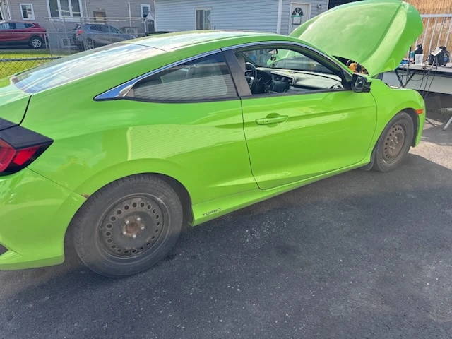 Bright green Honda Civic coupe with hood open parked outside during a mobile detail
