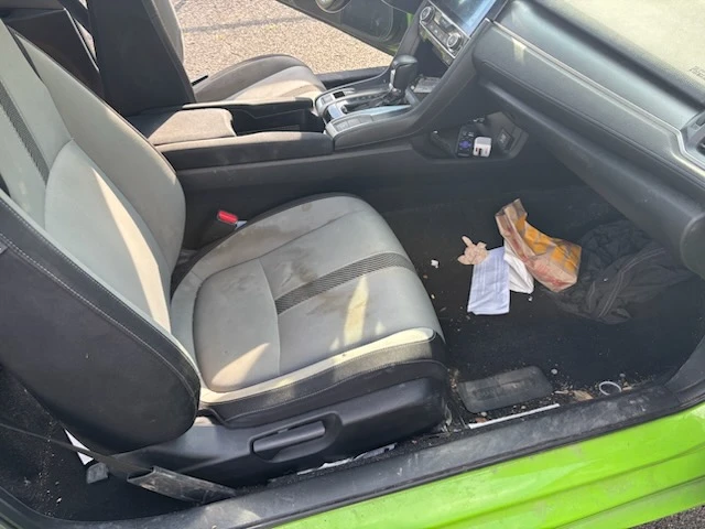 Honda Civic passenger seat and footwell with garbage and stained cloth before cleaning