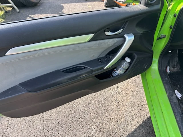 Dirty Honda Civic door panel with dust and grime before interior cleaning